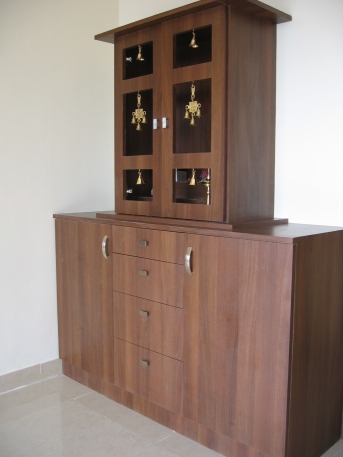 A Pooja unit with brass antiques combined with a storage unit