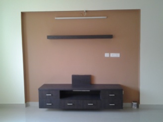 Mustard walls and contrasting brown display unit, with a custom made shelf